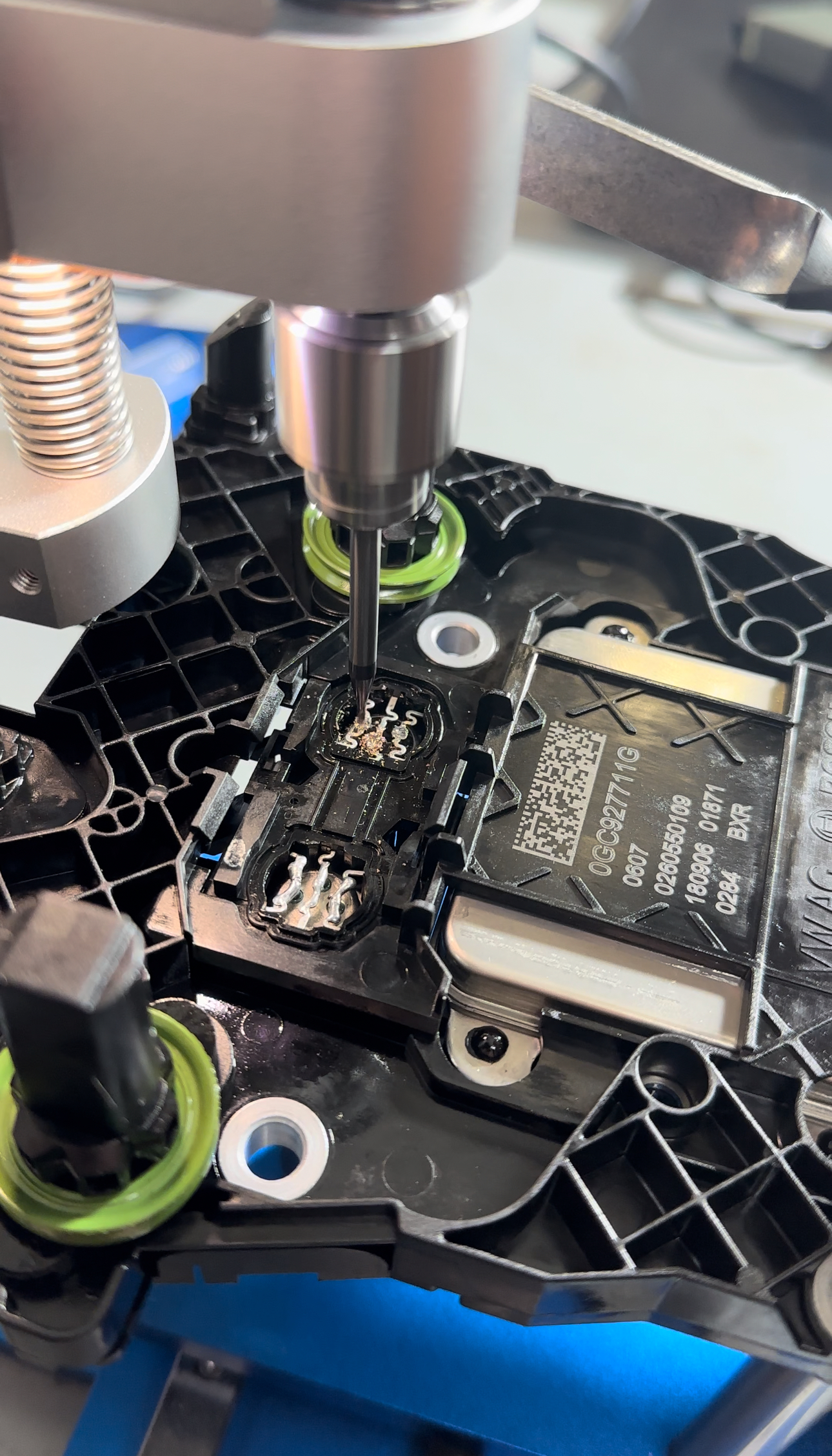 Mechanic installing new pressure sensor into mechatronic unit housing
